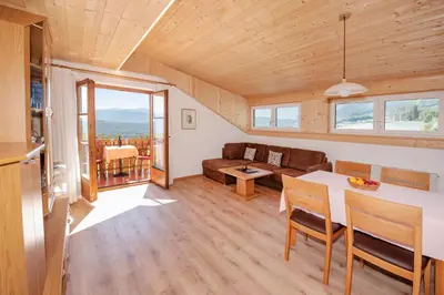 a living room with a table and a couch at Wolkanhof Vineyard Apartments in Appiano sulla Strada del Vino