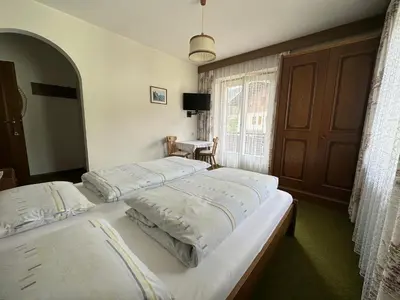 a bedroom with two beds and a window at APARTMENTS Gasser in Monguelfo