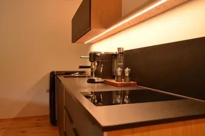 a kitchen counter with a coffee maker on it at Kastelart - Karbon in Castelrotto