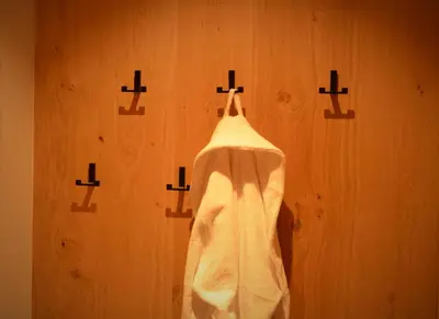 a robe hanging on a wall with crosses on it at Kastelart - Karbon in Castelrotto