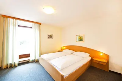 a bedroom with a bed and a window at Pension Hasslhof in Caldaro
