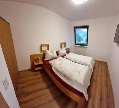 a bedroom with a bed and a window at Ottohof - Morgenrot in Brennero