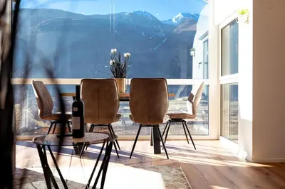 a kitchen counter with a sink and a plate of food at Posthof - Alpine Living Apartments in Campo di Trens