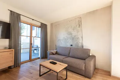 a living room with a couch and a table at Stadler Hof in Lana