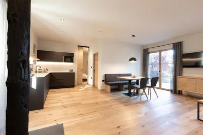 a kitchen and dining room with a table and chairs at Stadler Hof in Lana
