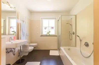 a bathroom with a sink and a shower and a toilet at Goldenhof Penon in Penone