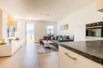a kitchen and living room with a couch and a table at Goldenhof Penon in Penone