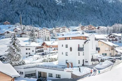 a town in the snow with buildings at Alpin Sport in Ortisei