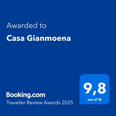 a blue screen with the text awarded to casa gimmeomonanca at Casa Gianmoena in Cavalese