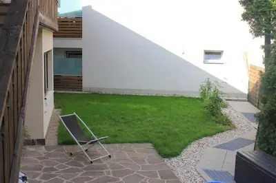 a chair sitting in the middle of a yard at Kehrerhof in Rifiano