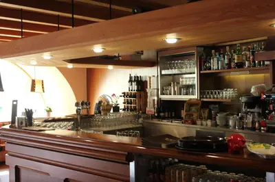 a bar in a restaurant with a counter top at Kehrerhof in Rifiano