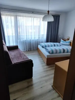 a living room with two beds and a couch at Kehrerhof in Rifiano