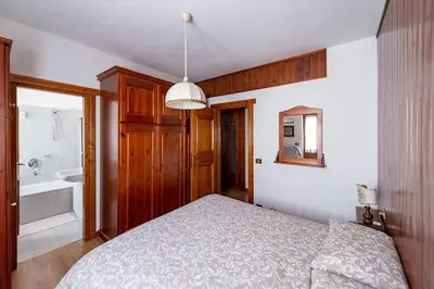 a bedroom with a bed and a bath tub at Appartamento centralissimo con wi-fi in Cortina dʼAmpezzo