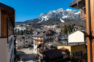 a view of a city with a mountain in the background at Appartamento centralissimo con wi-fi in Cortina dʼAmpezzo
