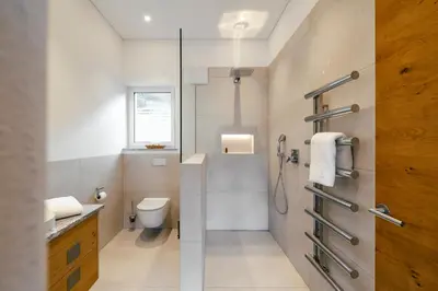 a bathroom with a shower with a toilet and a sink at Ferienhaus im Grünen in Terlano