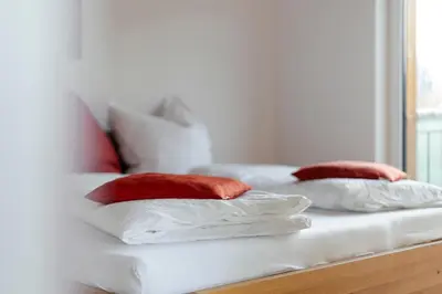 three pillows sitting on a white couch in a room at Ferienhaus im Grünen in Terlano