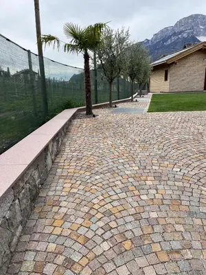 a brick road with a palm tree on it at Ferienhaus im Grünen in Terlano