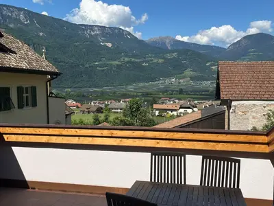 a balcony with a view of a town and mountains at Ferienhaus im Grünen in Terlano
