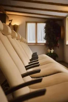 a row of chairs lined up in a room at Residence Rosarela in Badia