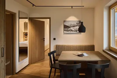 a dining room with a wooden table and chairs at Residence Rosarela in Badia