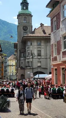a group of people walking down a street with a clock tower at Bolzano 2-Room Central Mountain View, WiFi Netflix AC Lift in Bolzano