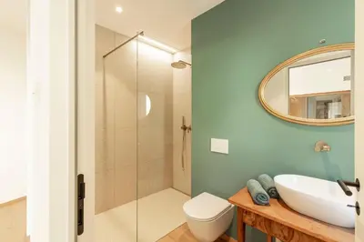 a bedroom with a bed with white and red pillows at Erbacher Living Nature Apartments Suites in Bolzano