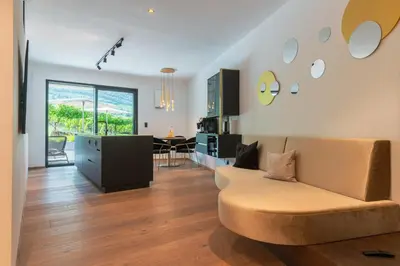 a living room with a couch and a table at Erbacher Living Nature Apartments Suites in Bolzano