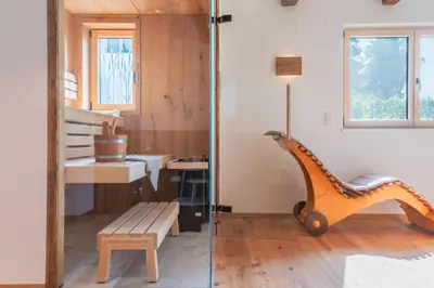 a room with a wooden bench and a stair case at Erbacher Living Nature Apartments Suites in Bolzano