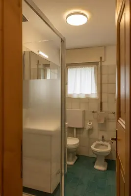 a bathroom with a toilet and a sink at Sorapis Mini - Monolocale Panoramico in Cortina dʼAmpezzo
