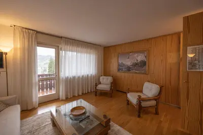 a living room with a couch and a table at Sorapis Mini - Monolocale Panoramico in Cortina dʼAmpezzo