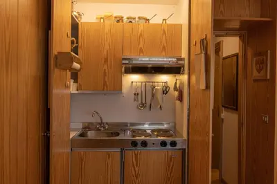 a kitchen with a sink and a stove at Sorapis Mini - Monolocale Panoramico in Cortina dʼAmpezzo