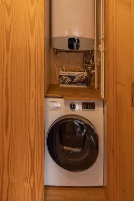 a washer and dryer in a small room at Sorapis Mini - Monolocale Panoramico in Cortina dʼAmpezzo