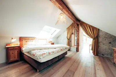 a bedroom with a large bed in a attic at Gschnoferhof Terlan in Terlano