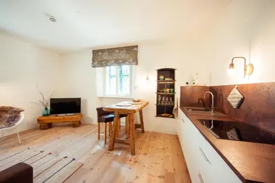 a kitchen with a wooden table and a sink at Gschnoferhof Terlan in Terlano
