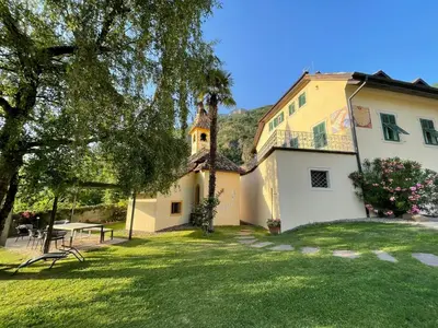 a large white house with a grass yard at Gschnoferhof Terlan in Terlano