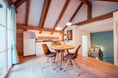 a kitchen and dining room with a table and chairs at Gschnoferhof Terlan in Terlano