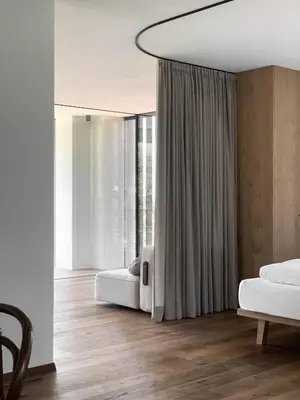 a bedroom with two beds and a large window at Kaiserau-Höfl in Bolzano