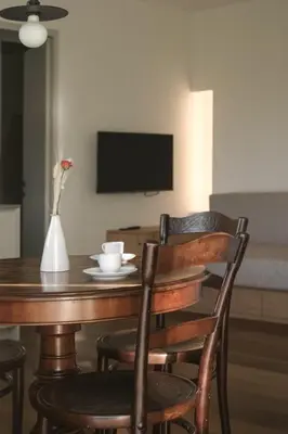a dining room table with a vase of flowers on it at Kaiserau-Höfl in Bolzano