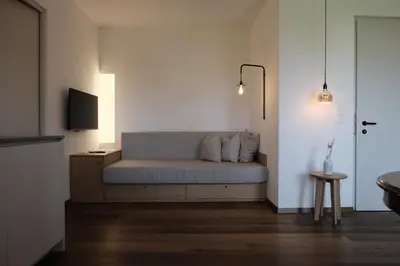 a living room with a couch and a tv at Kaiserau-Höfl in Bolzano