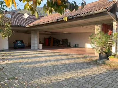 a garage with a car parked under a roof at Kaiserau-Höfl in Bolzano