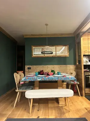 a dining room with a table and a bench at Cortina Center House in Cortina dʼAmpezzo