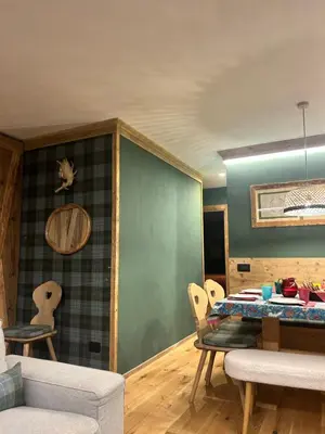 a living room with a table and chairs at Cortina Center House in Cortina dʼAmpezzo