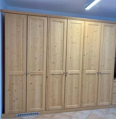 a row of wooden lockers in a room at Pragma Apartments - Appartamento La Torre in Predazzo