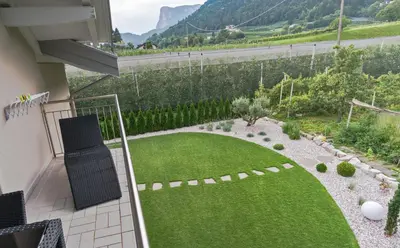 a patio with two chairs and a table at Ferienwohnungen Gamper in Tesimo