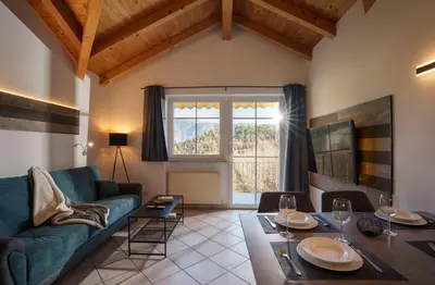 a living room with a couch and a table at Ferienwohnungen Gamper in Tesimo