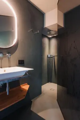 a bathroom with a sink and a shower at Max Green Forest Apartments in Siusi