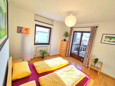 a living room with two beds and a window at Vidora Apartments - Dolomites Escape in Alpe di Siusi (Seiser Alm) in Fiè