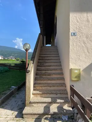 a set of stairs leading up to a building at Passione Dolomiti in Romeno