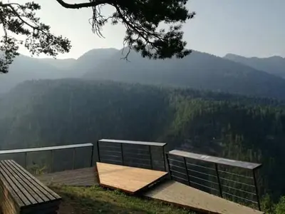 a wooden bench sitting on top of a mountain at Ciasa Erica - Val di Non in Predaia