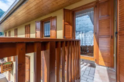 a balcony of a house with a large window at Condominio Orsa Maggiore 12 in Falcade